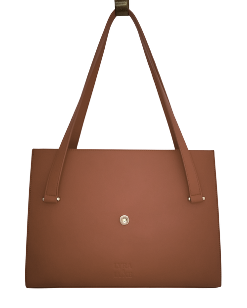 Brown tote bag with a visible brand logo on a white background